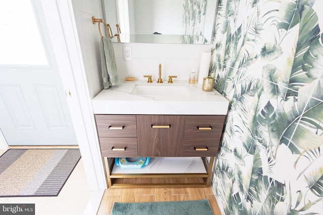 bathroom with vanity and wood finished floors