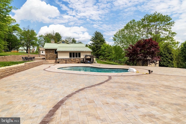 swimming pool featuring a patio area