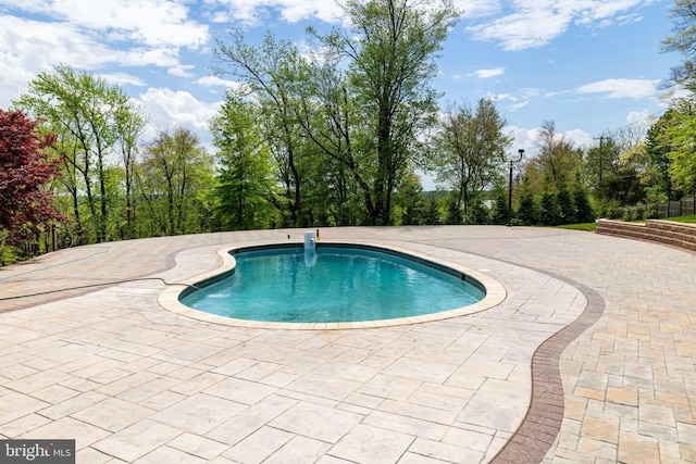 outdoor pool featuring a patio