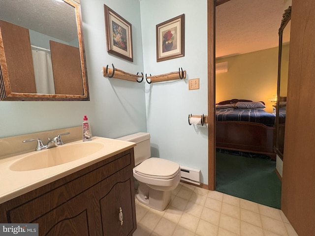 ensuite bathroom with a baseboard heating unit, vanity, toilet, and a textured ceiling