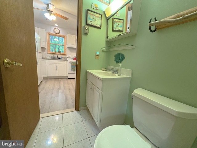 bathroom featuring toilet, ceiling fan, and vanity