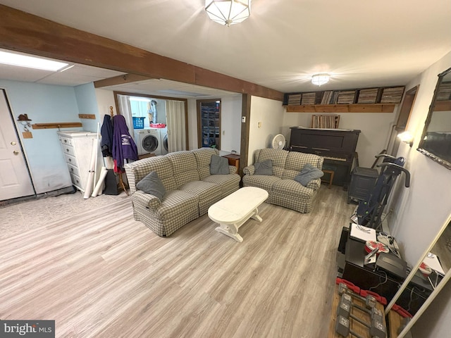 living room featuring washer and dryer and light wood-style floors