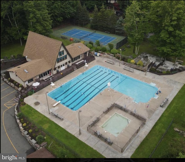 community pool featuring a patio and fence