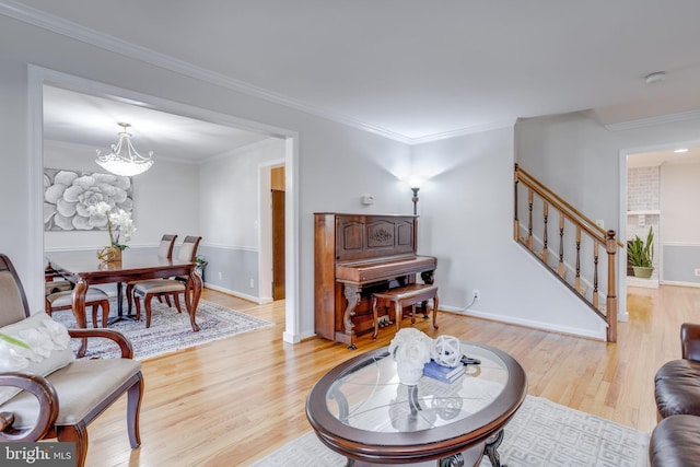 7530 Royce Ct, Annandale, VA 22003 - living room with stairs, light wood-style flooring, a chandelier, ornamental molding, and baseboards