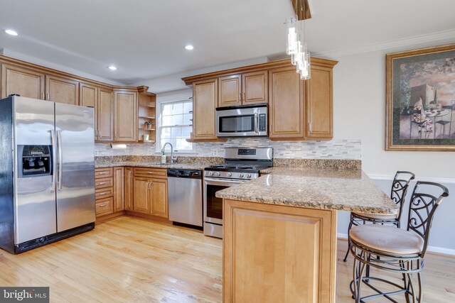 7530 Royce Ct, Annandale, VA 22003 - kitchen featuring appliances with stainless steel finishes, a peninsula, a sink, open shelves, and light wood-type flooring
