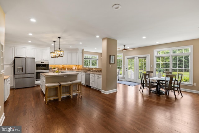 1002 Queen Annes Lace Way, Annapolis, MD 21401 - kitchen with appliances with stainless steel finishes, recessed lighting, white cabinets, a kitchen island with sink, and dark wood finished floors