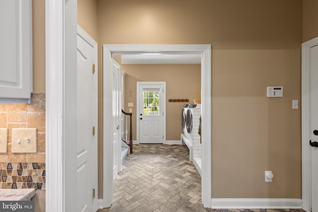 1002 Queen Annes Lace Way, Annapolis, MD 21401 - laundry area featuring washing machine and dryer, brick patterned floors, and baseboards
