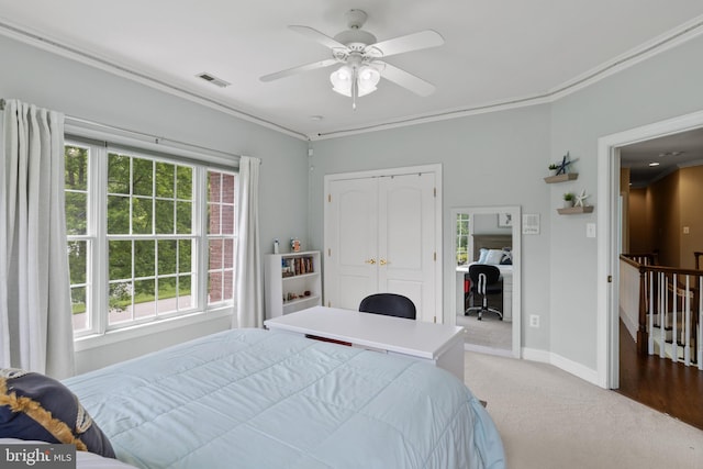1002 Queen Annes Lace Way, Annapolis, MD 21401 - bedroom with a desk, light carpet, ornamental molding, baseboards, and a closet