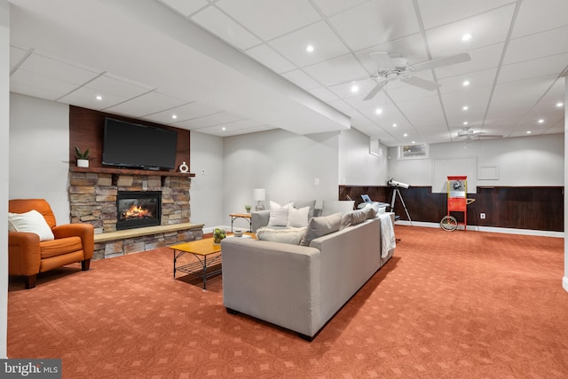1002 Queen Annes Lace Way, Annapolis, MD 21401 - living room with carpet flooring, a ceiling fan, a stone fireplace, wainscoting, and a drop ceiling
