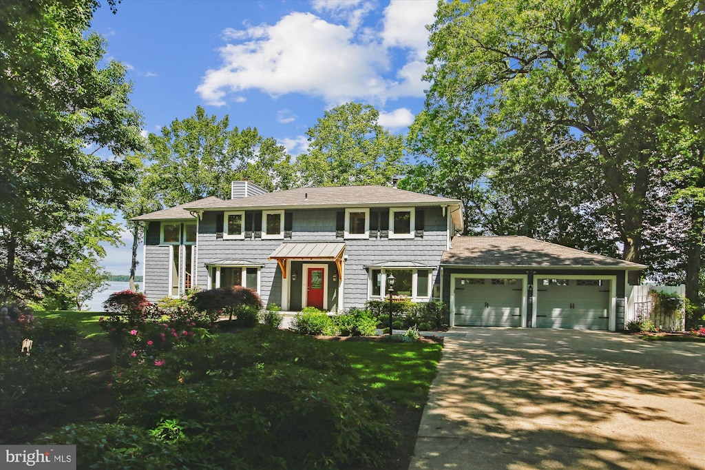 11801 River Dr, Lorton, VA 22079 - colonial home with a garage, concrete driveway, a chimney, a front lawn, and a shingled roof