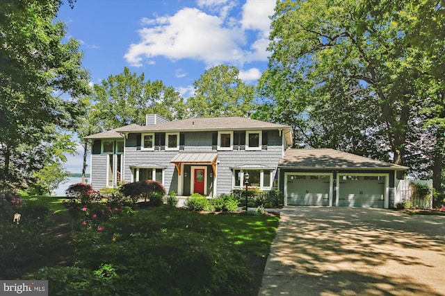 11801 River Dr, Lorton, VA 22079 - colonial home with a garage, concrete driveway, a chimney, a front lawn, and a shingled roof