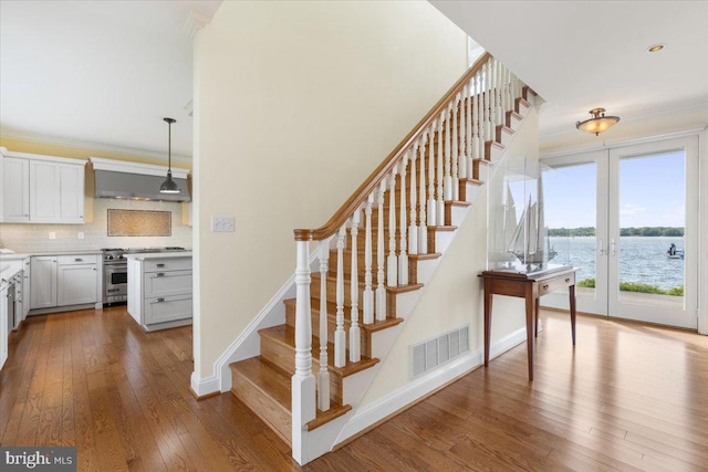 1100 Steamboat Rd, Shady Side, MD 20764 - stairs featuring hardwood / wood-style flooring, ornamental molding, baseboards, and a water view