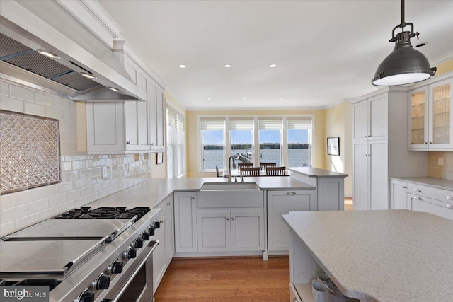 1100 Steamboat Rd, Shady Side, MD 20764 - kitchen featuring custom exhaust hood, high end stainless steel range, a sink, a peninsula, and light wood-style floors