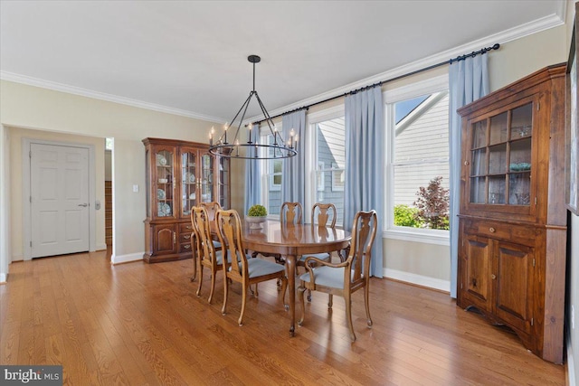 1100 Steamboat Rd, Shady Side, MD 20764 - dining space featuring a chandelier, crown molding, baseboards, and light wood finished floors