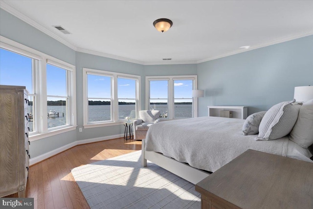 1100 Steamboat Rd, Shady Side, MD 20764 - bedroom with multiple windows, wood-type flooring, baseboards, a water view, and ornamental molding
