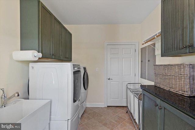 1100 Steamboat Rd, Shady Side, MD 20764 - washroom with washing machine and clothes dryer, cabinet space, baseboards, and light tile patterned flooring