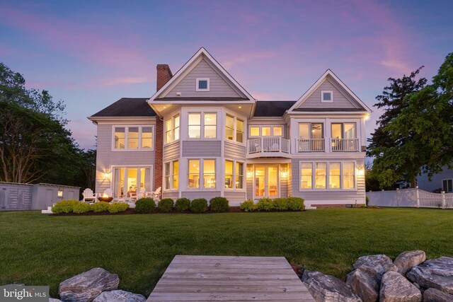 1100 Steamboat Rd, Shady Side, MD 20764 - back of property at dusk with a balcony, a chimney, and french doors