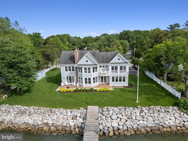 1100 Steamboat Rd, Shady Side, MD 20764 - back of house with a balcony, a patio area, a chimney, a forest view, and a water view