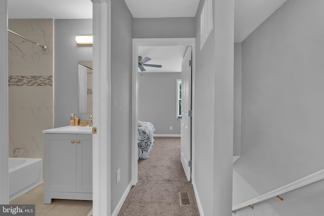 corridor with a sink and baseboards