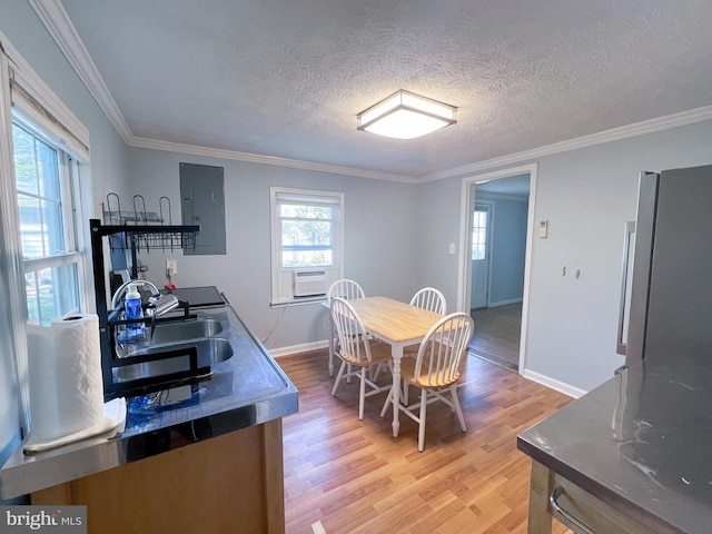 14308 Bristow Rd, Manassas, VA 20112 - dining room featuring light wood finished floors, baseboards, a textured ceiling, ornamental molding, and electric panel
