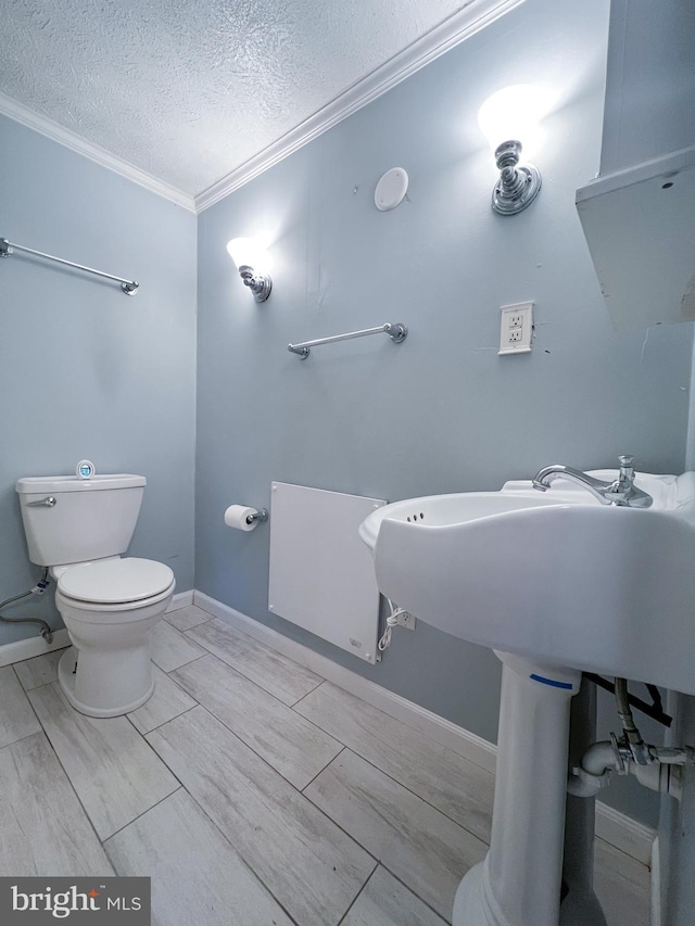 14308 Bristow Rd, Manassas, VA 20112 - half bathroom featuring crown molding, toilet, a textured ceiling, and baseboards