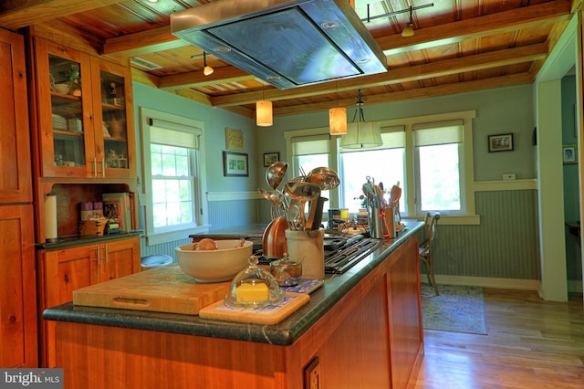14308 Bristow Rd, Manassas, VA 20112 - kitchen with wooden ceiling, brown cabinetry, light wood-type flooring, a center island, and a wainscoted wall