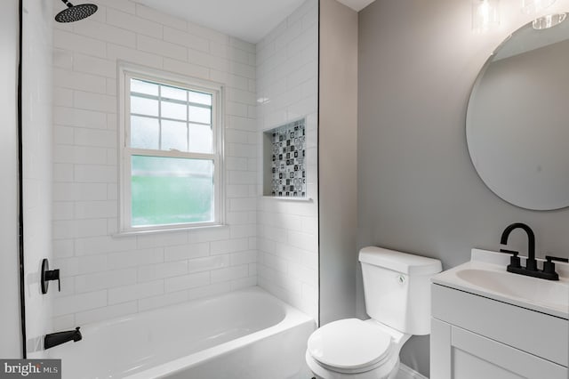 bathroom featuring toilet, vanity, and tub / shower combination