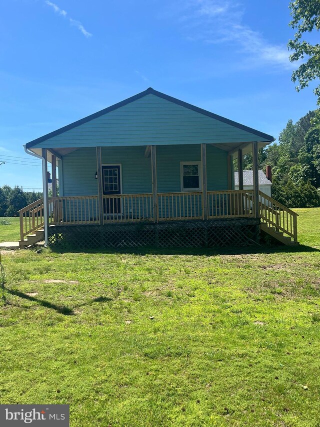 1807 Calvary Church Rd, Warsaw, VA 22572 - view of front facade with a porch and a front lawn