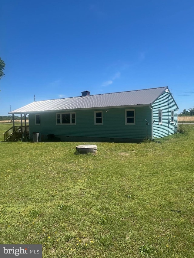 1807 Calvary Church Rd, Warsaw, VA 22572 - rear view of property with a yard, metal roof, cooling unit, and a chimney