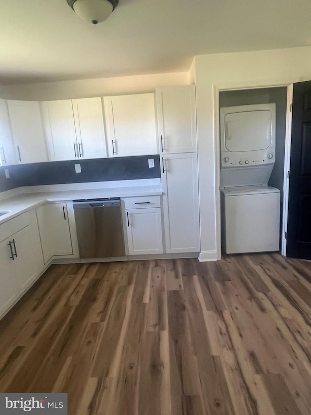 1807 Calvary Church Rd, Warsaw, VA 22572 - kitchen with estacked washer and dryer, dishwasher, white cabinetry, wood finished floors, and light countertops