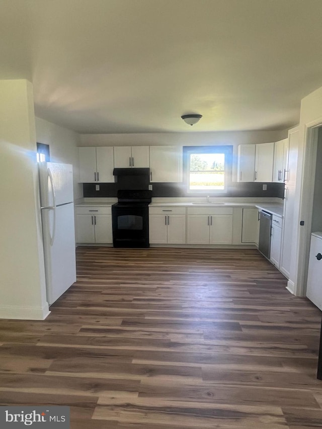 1807 Calvary Church Rd, Warsaw, VA 22572 - kitchen with black range with electric stovetop, freestanding refrigerator, dishwasher, a sink, and white cabinets