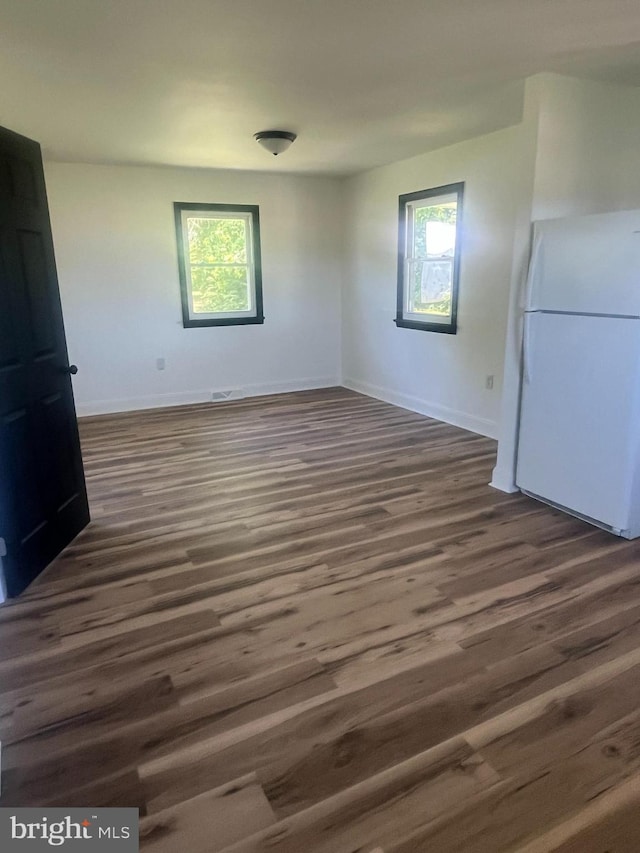 1807 Calvary Church Rd, Warsaw, VA 22572 - unfurnished dining area with dark wood-style flooring, healthy amount of natural light, and baseboards