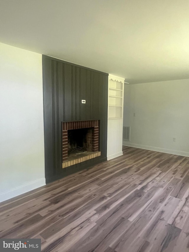 1807 Calvary Church Rd, Warsaw, VA 22572 - unfurnished living room featuring a fireplace, baseboards, and wood finished floors