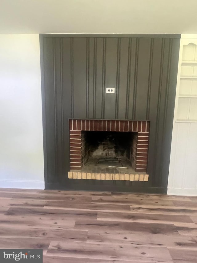 1807 Calvary Church Rd, Warsaw, VA 22572 - detailed view of a brick fireplace, wood finished floors, and baseboards
