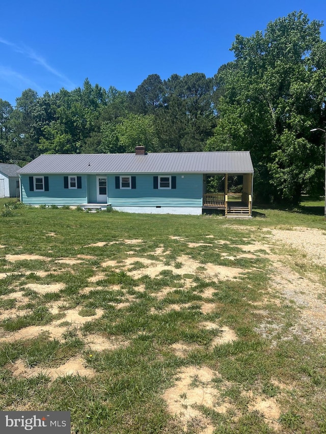 1807 Calvary Church Rd, Warsaw, VA 22572 - view of front of property with metal roof, a view of trees, a front lawn, and a chimney