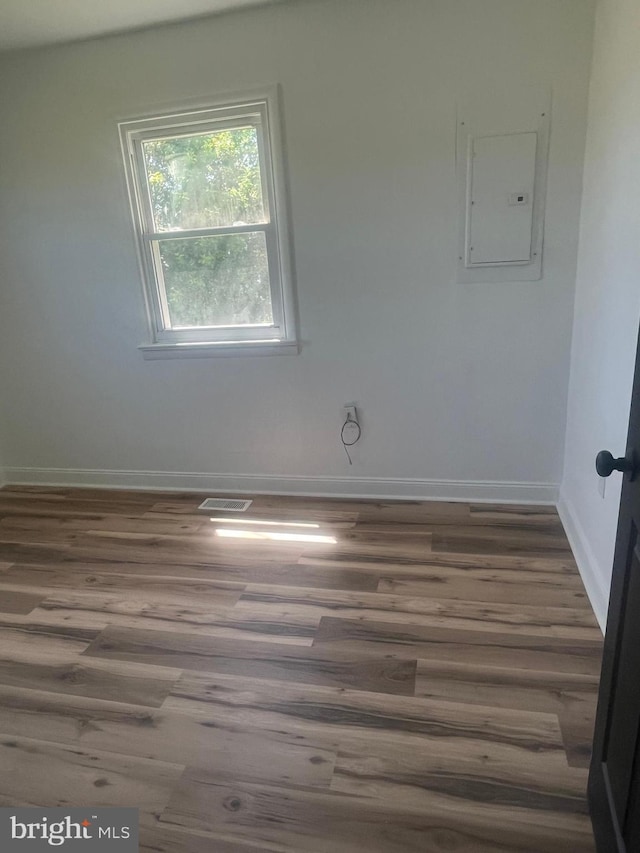 1807 Calvary Church Rd, Warsaw, VA 22572 - spare room with electric panel, baseboards, and wood finished floors