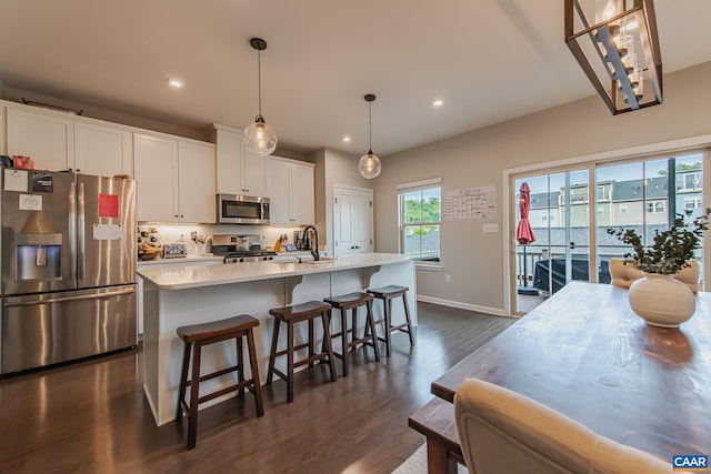 1509 Delphi Ln, Charlottesville, VA 22911 - kitchen featuring stainless steel appliances, a sink, dark wood-style flooring, light countertops, and an island with sink