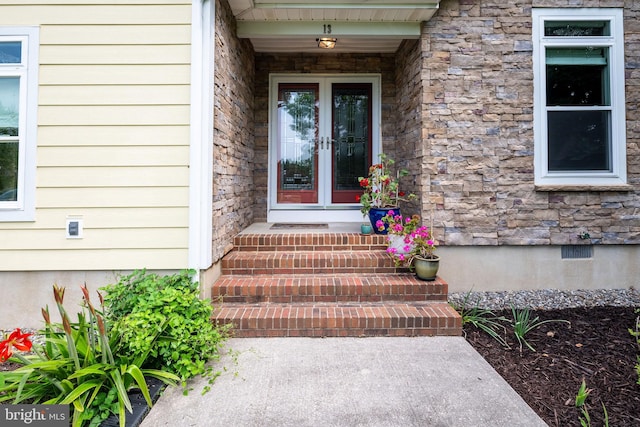 13 Deerfield Ln, Rehoboth Beach, DE 19971 - view of exterior entry featuring french doors, stone siding, and crawl space