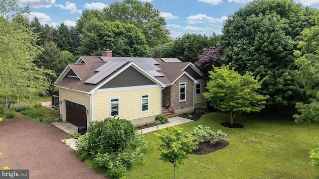 13 Deerfield Ln, Rehoboth Beach, DE 19971 - craftsman-style home with a garage, a front yard, roof mounted solar panels, and a chimney