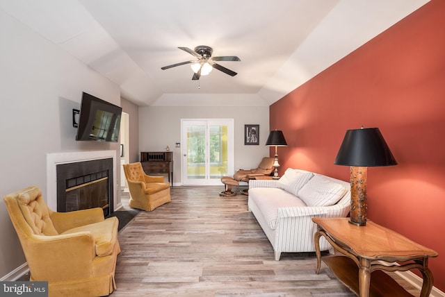 13 Deerfield Ln, Rehoboth Beach, DE 19971 - living room with a ceiling fan, wood finished floors, a fireplace with flush hearth, and a raised ceiling