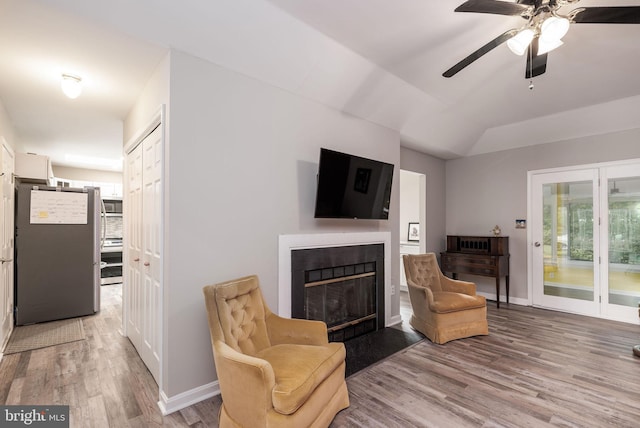 13 Deerfield Ln, Rehoboth Beach, DE 19971 - living room with light wood finished floors, ceiling fan, a fireplace with flush hearth, baseboards, and vaulted ceiling