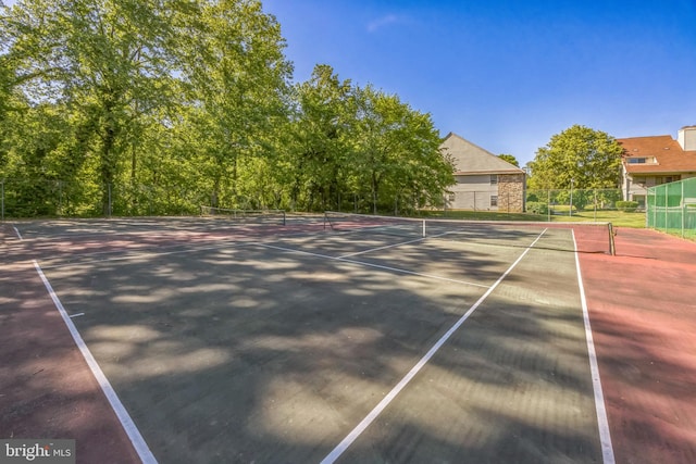 view of tennis court featuring fence