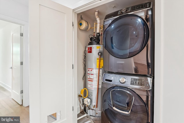 5110 Fort Totten Dr NE Unit P4, Washington, DC 20011 - laundry room featuring stacked washer / dryer and gas water heater