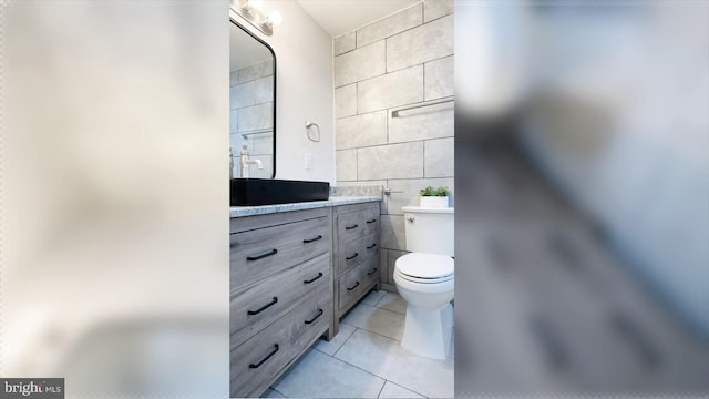 8802 Ashford Rd, Parkville, MD 21234 - bathroom with tile walls, tile patterned floors, toilet, and vanity