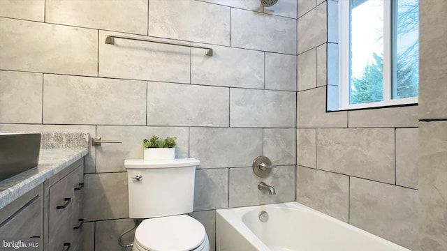 8802 Ashford Rd, Parkville, MD 21234 - bathroom with plenty of natural light, a bathtub, toilet, tile walls, and vanity
