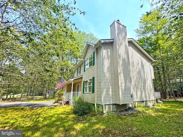 251 Depuy Dr, Pocono Lake, PA 18347 - view of side of property with a chimney and a lawn