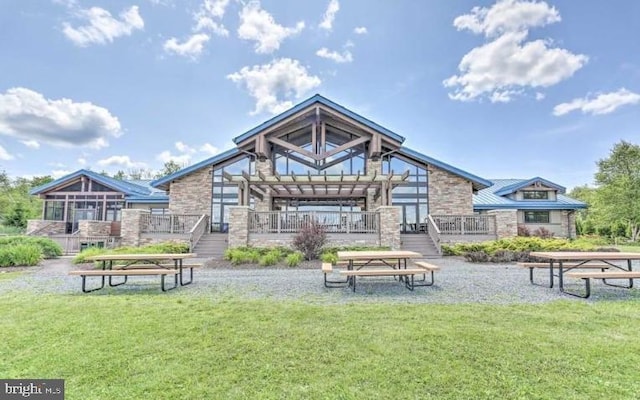 251 Depuy Dr, Pocono Lake, PA 18347 - back of house featuring stone siding, a wooden deck, and a yard
