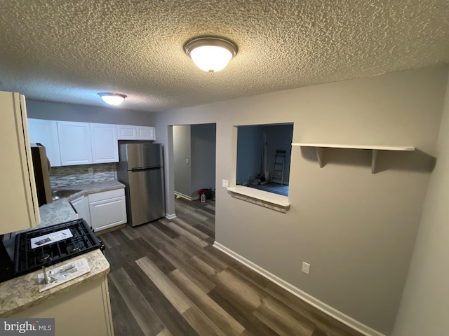 155 Sussex Pl Unit 1522, Absecon, NJ 08205 - kitchen featuring freestanding refrigerator, white cabinetry, light countertops, dark wood-style floors, and a textured ceiling