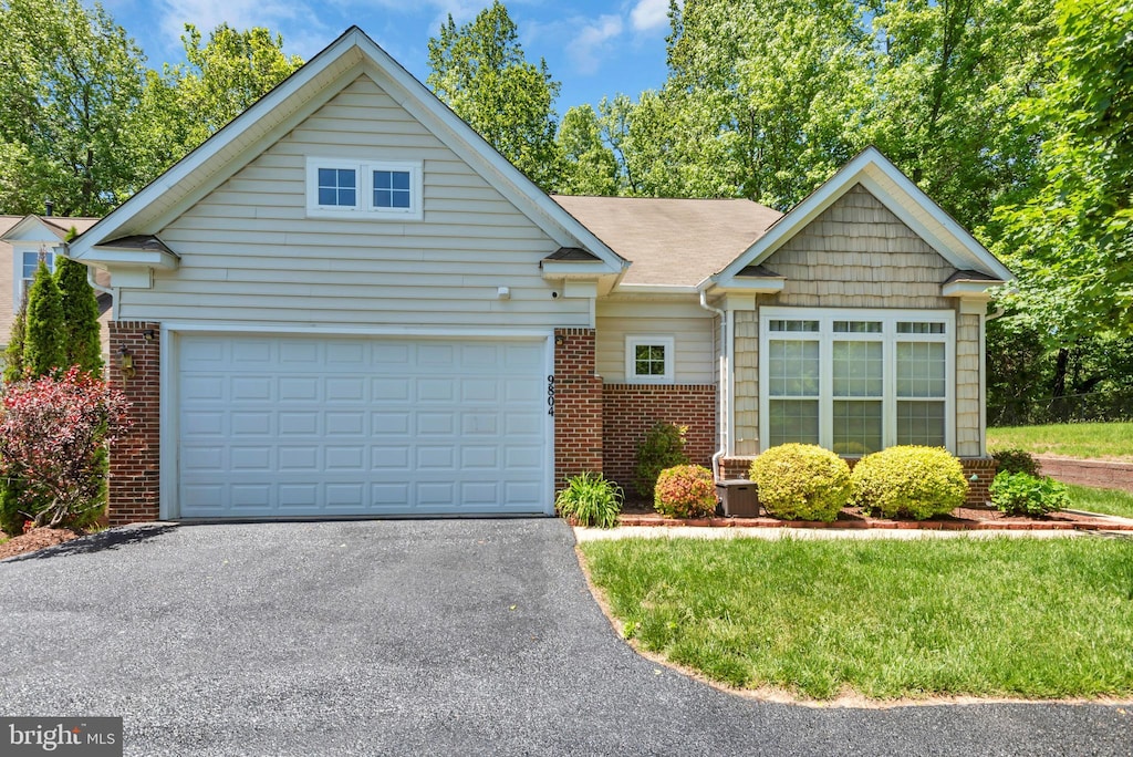 9804 Stonewood Ct, Upper Marlboro, MD 20772 - view of front facade featuring brick siding, asphalt driveway, and an attached garage