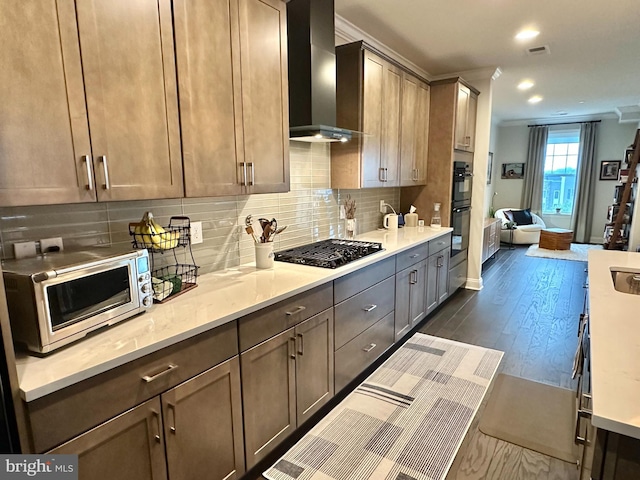 kitchen with black appliances, wall chimney range hood, dark wood finished floors, light countertops, and recessed lighting